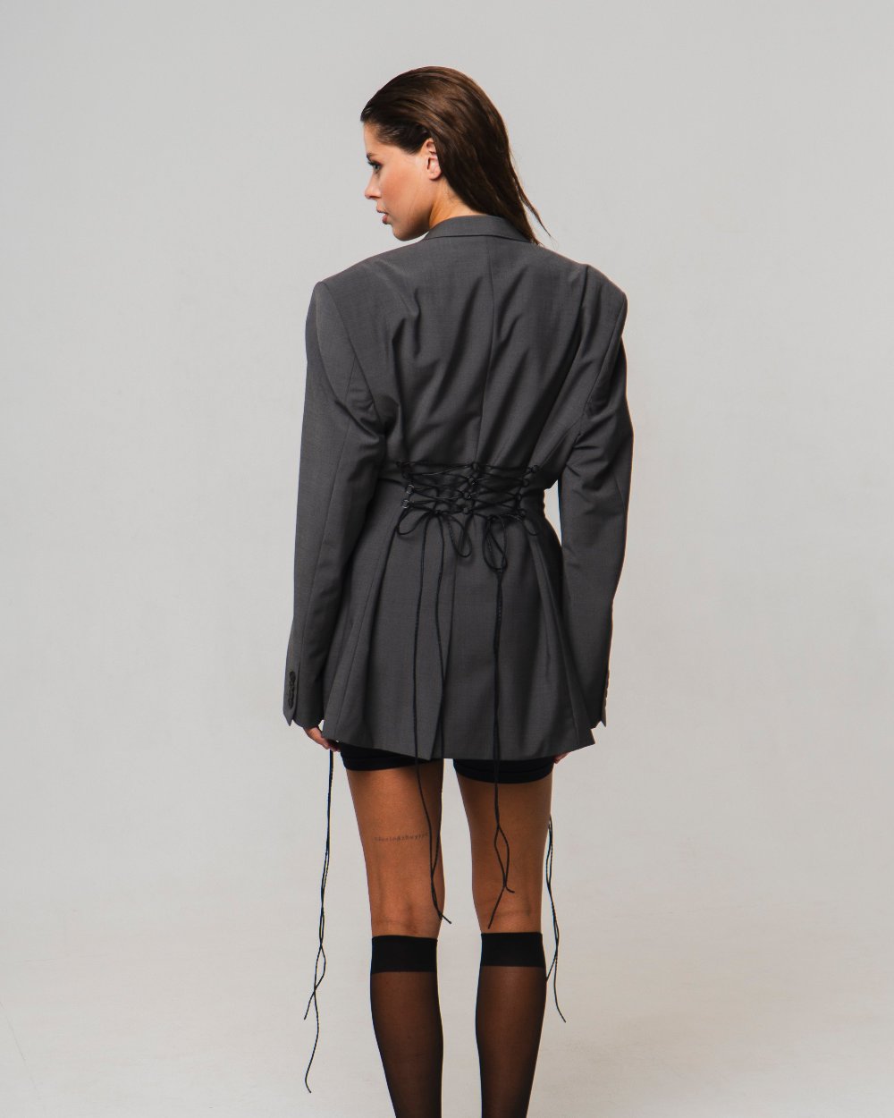 UPCYCLED JACKET with adjustable drawstrings with a man's shoulder